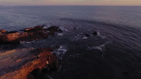 Drone shot over Malibu beach rocks by the ocean Rec709 Stock Footage 84540045