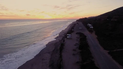 Drone shot over Malibu beach rocks by the ocean Rec709 Stock Footage 84546540