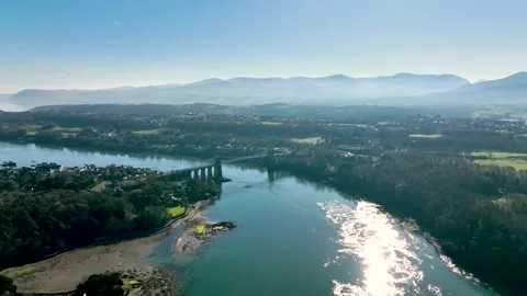 Drone shot over Menai Bridge with Snowdownia Stock Footage 199247883