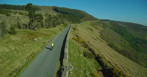 Drone Shot Over Mountain Road With Cyclist Stock Footage 131990324