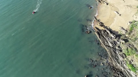 Drone Shot Over Ocean, Beach and Moving Jetski Stock Footage 100389529