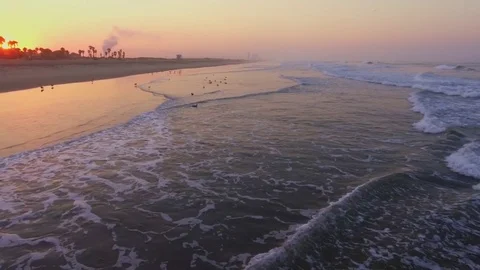 Drone shot over the ocean shoreline flying over the pier on sunrise Rec709 Stock Footage 82745446