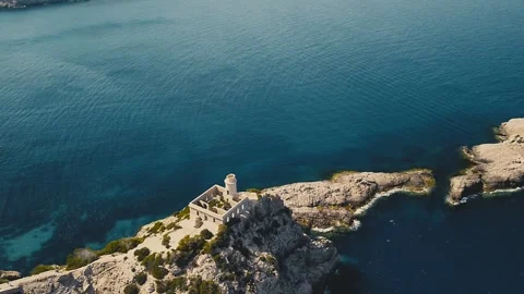 Drone Shot Over the Old Lighthouse in Cala de Sant Vicent in Ibiza Stock Footage 311590360