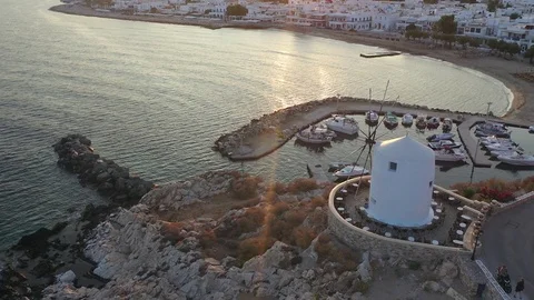 Drone shot over old windmill into sunrise on Paros in Greek Islands Stock Footage 121801673