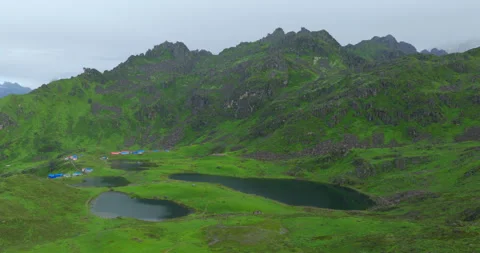 Drone shot over Panchpokhari's five glacial lakes nestled in green valleys of Stock Footage 345229516