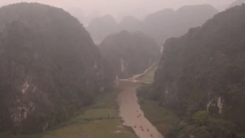 Drone shot over river cutting through dramatic cliffs in the mountainous Stock Footage 277321692