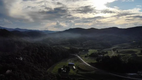 Drone Shot over Road Through Mountain Pass with Barn Below Stock Footage 94134236