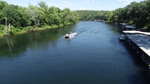 Drone shot over a running river and tracking a boat Video stock 93390923