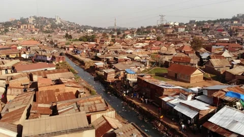 Drone shot over the slums of Uganda, moving along a river, poverty and rubbish. Stock Footage 201264818