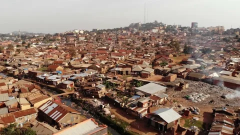 Drone shot over the slums of Uganda, going backwards. With a river flowing. Stock Footage 201264951