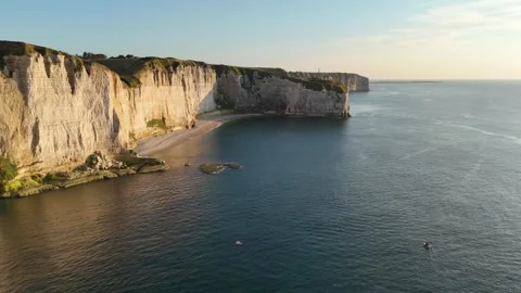 Drone shot over white cliffs and sandy beach, golden hour light, Etretat France Stock Footage 346477226