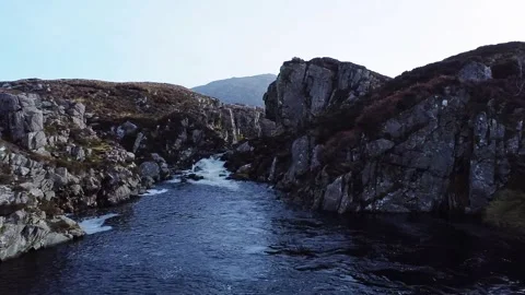 A drone shot over a wild river gorge in the Outer Hebrides, Scotland, UK Stock Footage 171220003