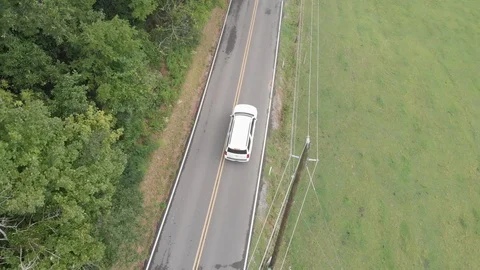 Drone Shot overhead of White SUV Driving through Mountain Road Stock Footage 94132955