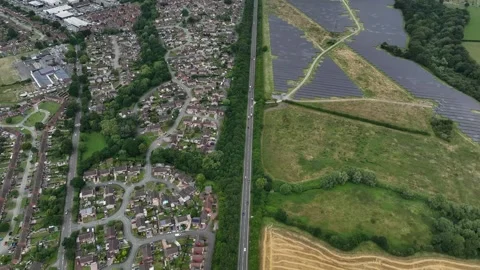 Drone shot panning down a road into a roundabout Video stock 246977818
