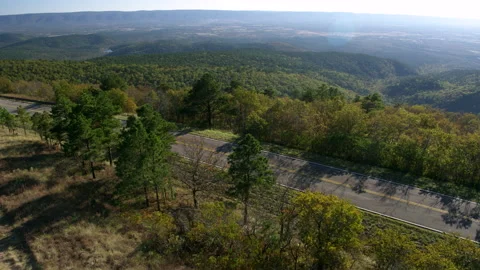 Drone Shot Panning With an RV as it Drives Through a Forested Highway Stock Footage 149458102