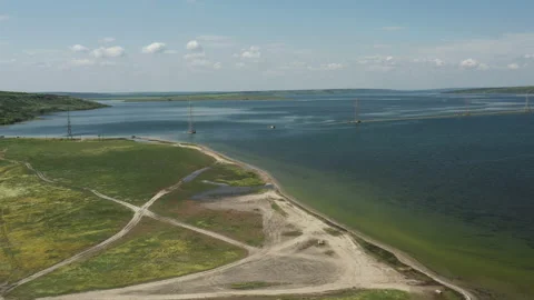 Drone shot panorama of power lines standing across the lake at summer Stock Footage 187542780