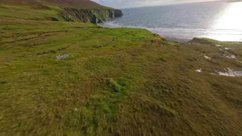 Drone shot of a paraglider soaring at the cliffs of Keel beach, Stock Footage 274177954