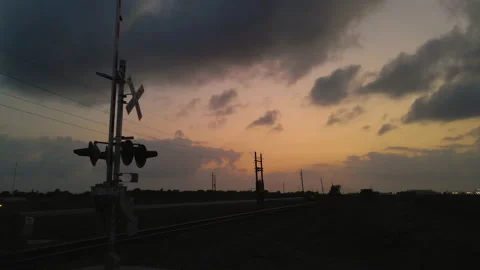 Drone Shot Passing Low By Silhouetted Railroad Crossing Sign In Texas, Stock Footage 188437491