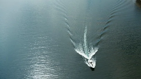 Drone shot passing over white boat wake pattern Stock Footage 90269327