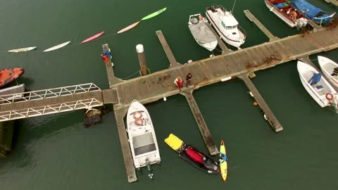 Drone shot of people preparing before jet ski riding on pier at harbour Video stock 163283142