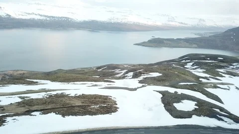 Drone Shot of people skiing and snowboarding on a snowy mountain in Eastfjords Stock Footage 118320632