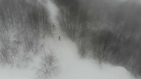 Drone shot of people skiing on Mount Himba Stock Footage 232863433