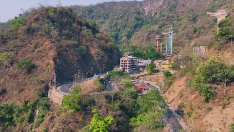 Drone shot pf S- curve Road and moving traffic near Rishkesh shivpuri uttra.. Video stock 309634707