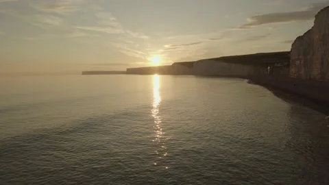 Drone shot pull back to reveal sunset beach Stock Footage 132818187