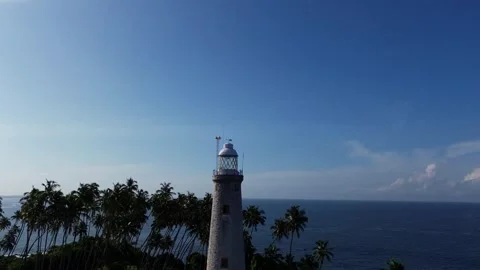 Drone shot pulling away from Barberyn Lighthouse, island off Beruwela Stock Footage 309540698