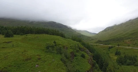 Drone Shot Pulling Back over Scottish Hills on a Cloudy Day 動画素材 97592838