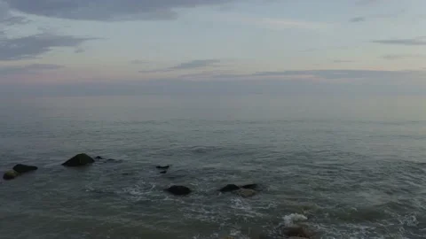 Drone shot pulls back from calm sea to reveal beach Stock Footage 132817919