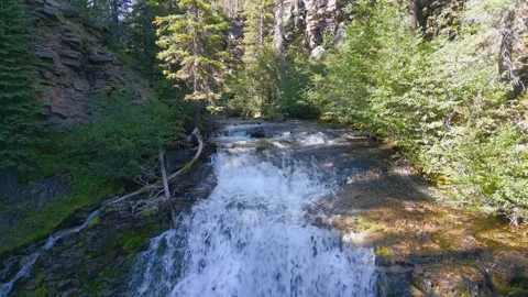 Drone shot pulls back revealing a waterfall in the woods Stock Footage 318476990