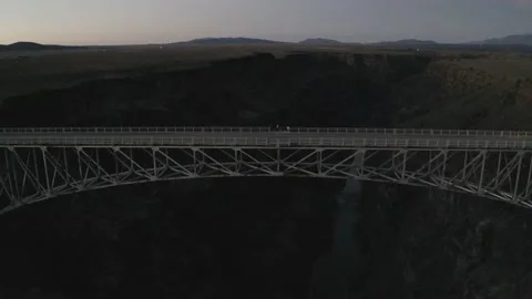 Drone shot pulls backwards from bridge to reveal its desert location Stock Footage 167666491