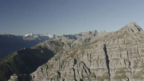 Drone shot Push in over mountain shoulder in the alps 動画素材 164304370