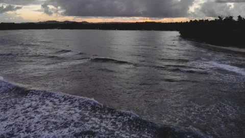 Drone shot of reef beach with waves at twilight with clouds 库存影片 130843390