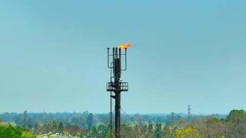 A drone shot of a refinery flare system burning excess gas. Stock Footage 332468588