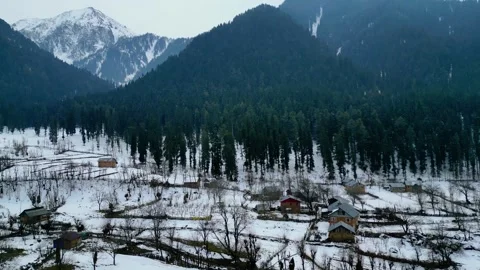 Drone shot of remote Himalayan valley blanketed in snow Stock Footage 310657687