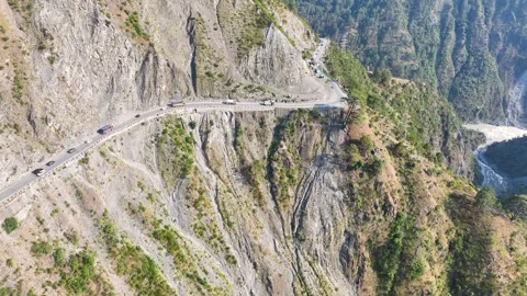Drone shot of remote logistics trucks stuck on landslide prone highway. Stock Footage 337616378