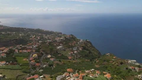 Drone shot revealing a panoramic view from Canhas down to Ponta do Sol Stock Footage 345643073