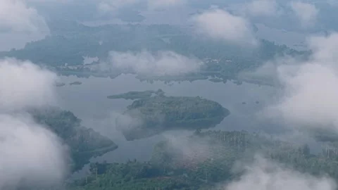 Drone shot reveals floating islands through swirling clouds Stock Footage 344816944