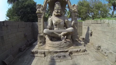 Drone shot rising from Narasimha statue to palms and sky in Hampi India. Stock Footage 330216746