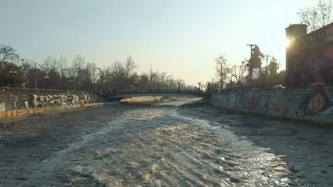 Drone shot rising over paved river waterway in Santiago de Chile Stock Footage 121596752