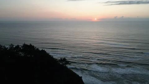 Drone shot rising up over vast ocean at sunset Stock Footage 249028005