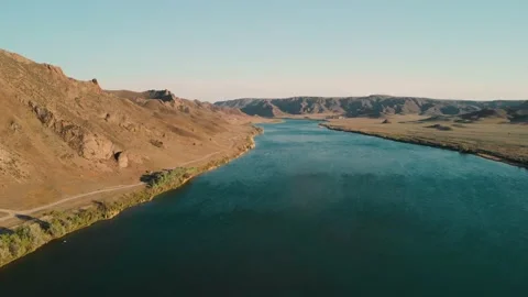 Drone shot of river and mountains at sunset in Kazakhstan Stock Footage 155265932
