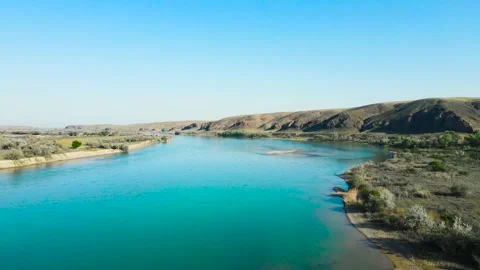 Drone shot of river and mountains at sunset in Kazakhstan Video stock 194469596