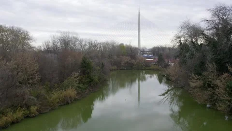 Drone shot of a river with a city in the background Video stock 256107154