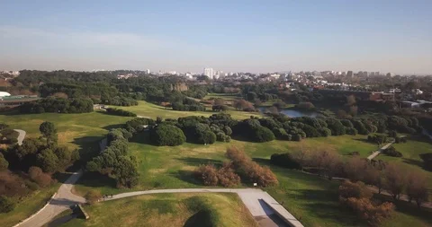 Drone shot of river flowing through green forest overlooking cityscape, Porto Stock Footage 114854543