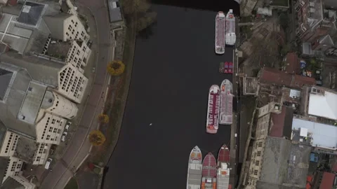 A drone shot of the River Ouse with moored boats and surrounding architecture in Video stock 296761550