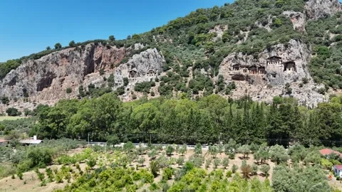 Drone shot of Rock-cut temple tombs in Ancient city of Kaunos, Dalyan Stock Footage 336386400