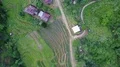Drone shot rotation aerial jungle mountain village rice field buildings footpath 4k or 4k+ Resolution
